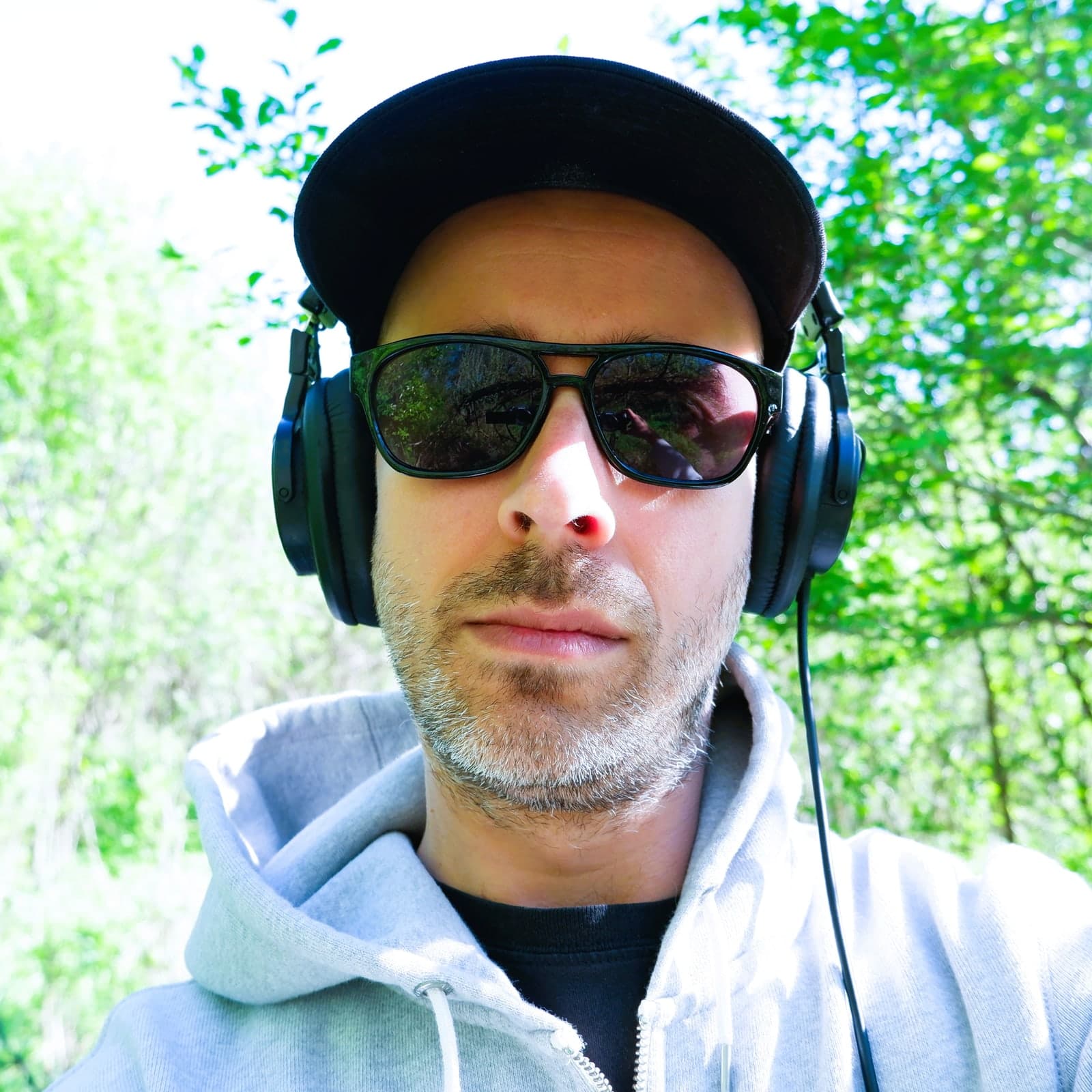 Outdoor portrait of Richard Gillespie wearing sunglasses and headphones