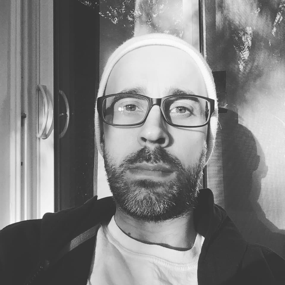 Black and white portrait of Richard Gillespie in window light